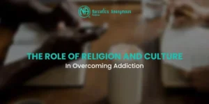 An image with a blurred background showing people at a table, featuring the Narcotics Anonymous Pakistan logo and the text "THE ROLE OF RELIGION AND CULTURE In Overcoming Addiction."